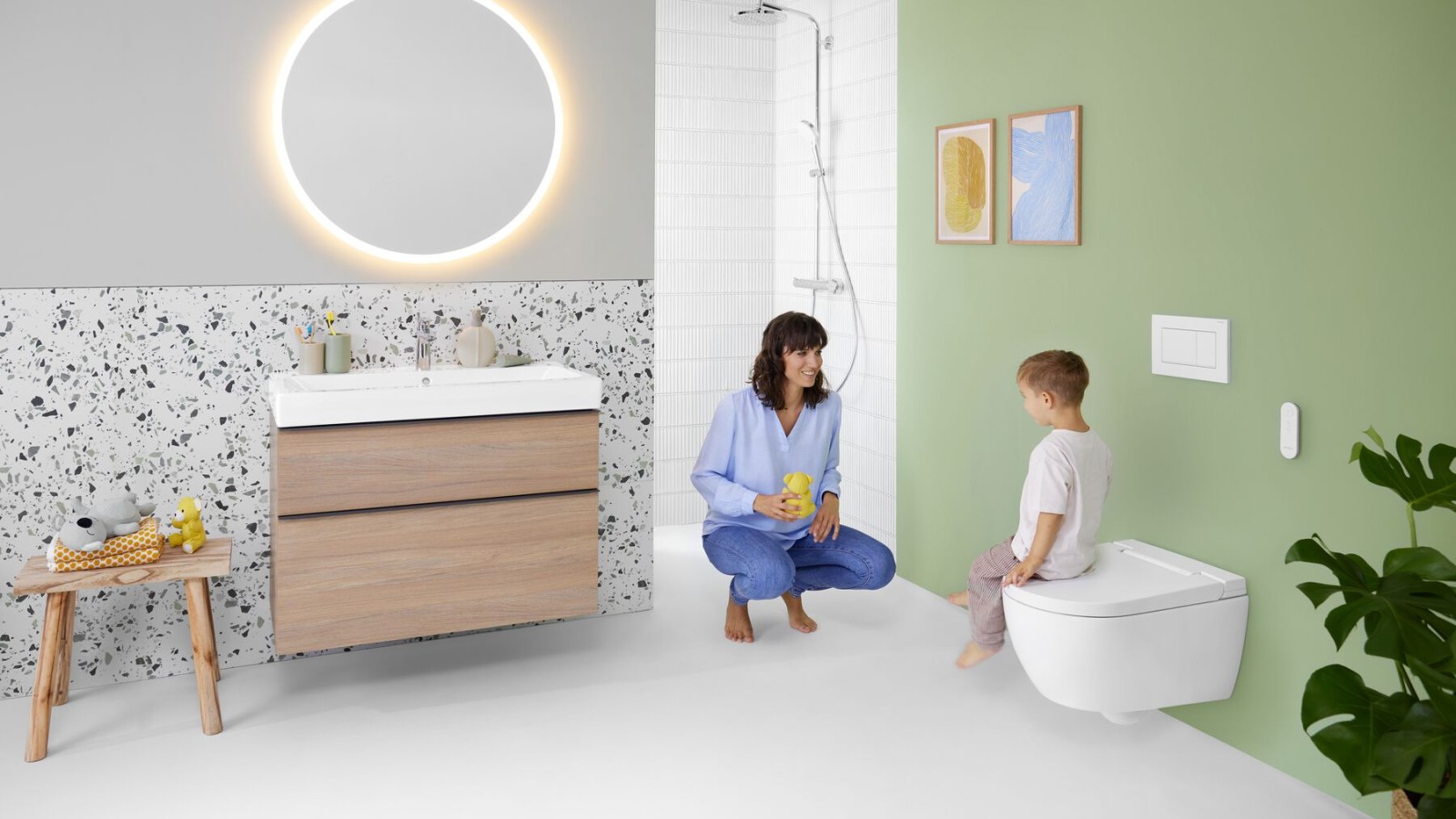 Woman and child in a colourful bathroom with Geberit Option mirror and Geberit AquaClean Alba Woman and child in a colourful bathroom with Geberit Option mirror and Geberit AquaClean Alba