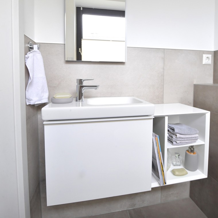 View of the guest bathroom with washbasin and cabinets